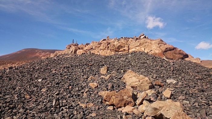 A prehistoric shrine with upright stones set in the lava rock, located above the quarry. The grey stones are all flakes and half-worked adzes, residues of 600 years of adze production.