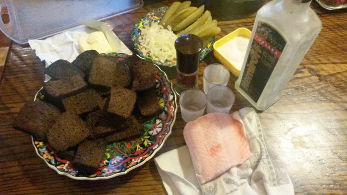 Russian classy Stroganina: fried bread slices in butter, sliced raw salmon on the bread with pickle,onion and black pepper. you eat it after you drink the shot of vodka. the taste is inexplainable. (Kiev)