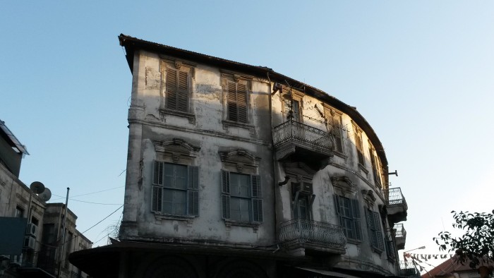 an old building trying to survive among urban restructuring that spreads all around the city.