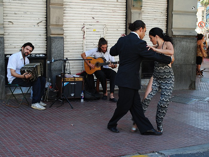 a couple dancing on the streets of San Telmo