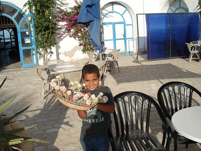 This is on the island Djerba. Little boy is selling Machmoum.