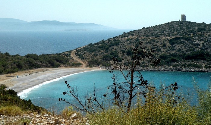 The wild beach Trahili, in the background on the hill very well preserved Watchtower